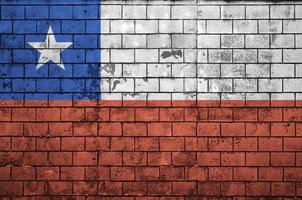 Chile flag is painted onto an old brick wall photo