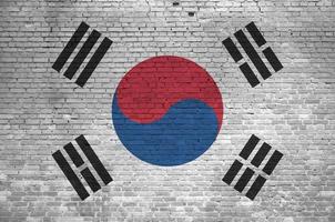 South Korea flag depicted in paint colors on old brick wall. Textured banner on big brick wall masonry background photo