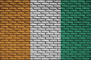 Ivory Coast flag is painted onto an old brick wall photo