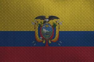 Ecuador flag depicted in paint colors on old brushed metal plate or wall closeup. Textured banner on rough background photo