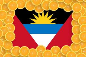 Antigua and Barbuda flag  in fresh citrus fruit slices frame photo