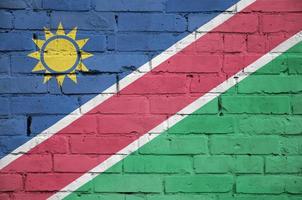 Namibia flag is painted onto an old brick wall photo