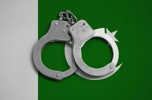 Pakistan flag  and police handcuffs. The concept of observance of the law in the country and protection from crime photo