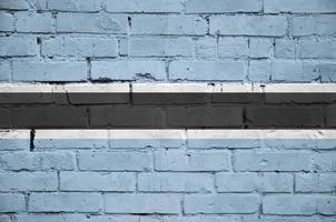 Botswana flag is painted onto an old brick wall photo