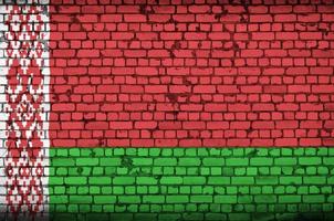 Belarus flag is painted onto an old brick wall photo