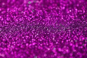 Pink decorative sequins. Background image with shiny bokeh lights from small elements photo