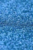 Blue decorative sequins. Background image with shiny bokeh lights from small elements photo