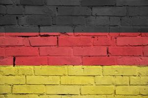 Germany flag is painted onto an old brick wall photo