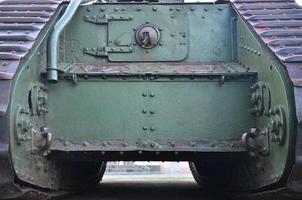 Texture of tank side wall, made of metal and reinforced with a multitude of bolts and rivets photo