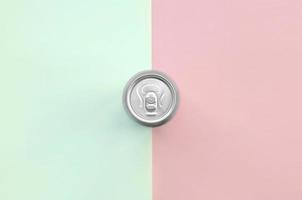 Metallic beer can on texture background of fashion pastel turquoise and pink colors photo