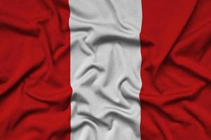 Peru flag  is depicted on a sports cloth fabric with many folds. Sport team banner photo