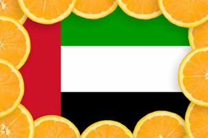 United Arab Emirates flag  in fresh citrus fruit slices frame photo