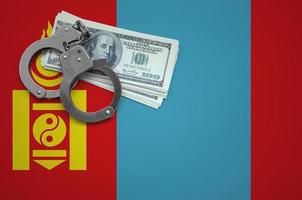 Mongolia flag  with handcuffs and a bundle of dollars. The concept of breaking the law and thieves crimes photo