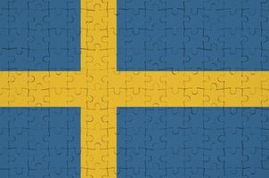 Sweden flag  is depicted on a folded puzzle photo