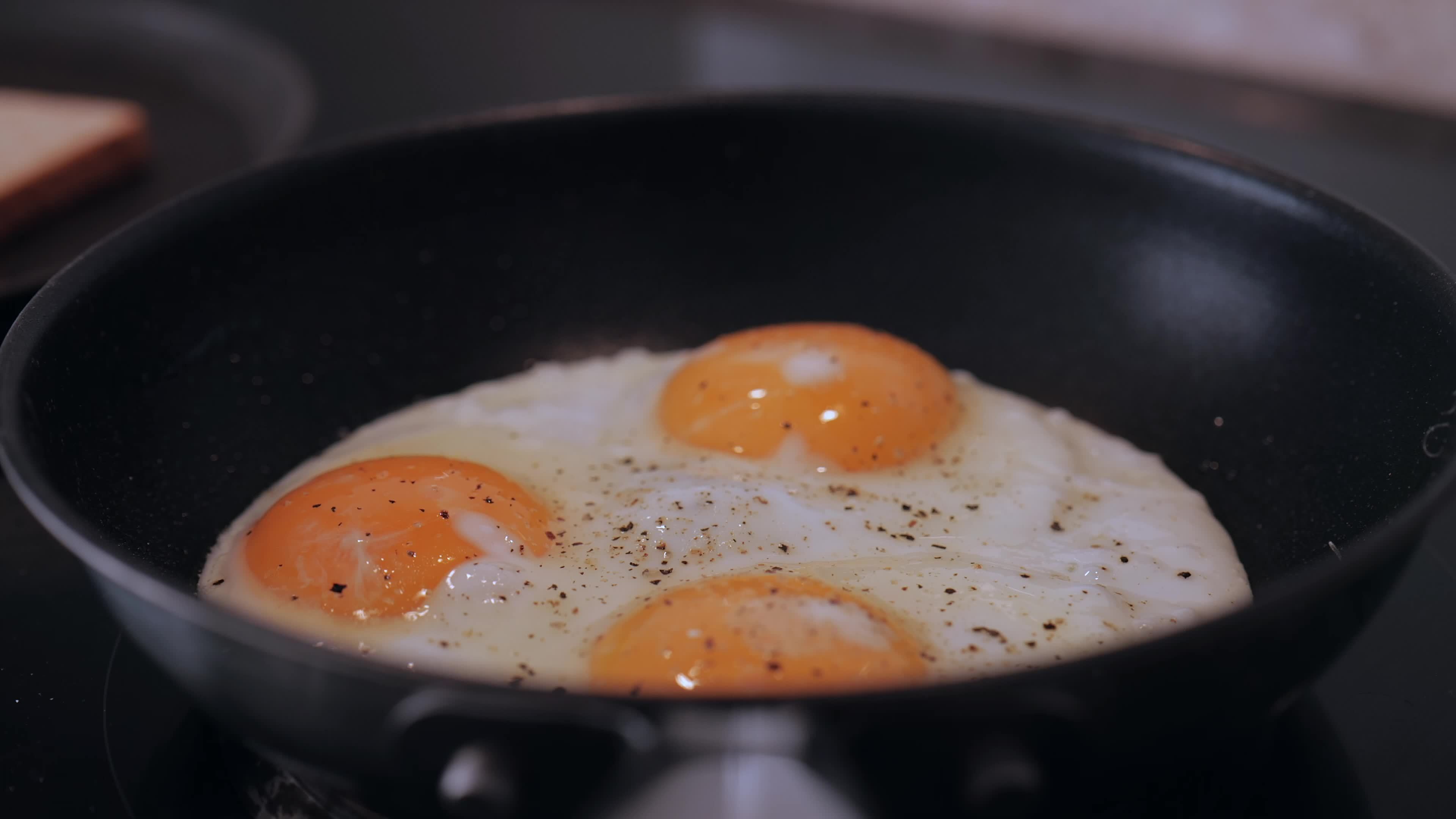 frying eggs in a frying pan 13277861 Stock Video at Vecteezy
