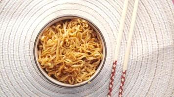 Overhead panning of bowl of ramen noodles on placemat with chopsticks video