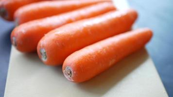 Fresh carrots lined up on cutting board video