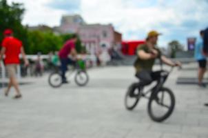 Defocused image of a lot of people with bmx bikes. Meeting of fans of extreme sports photo