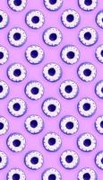 Many small plastic donuts lies on a pastel colorful background. Flat lay minimal pattern. Top view photo