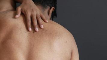 Adult man rubs back of bare neck and back video