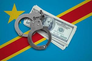 Democratic Republic of the Congo flag  with handcuffs and a bundle of dollars. Currency corruption in the country. Financial crimes photo