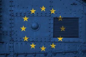 European union flag depicted on side part of military armored tank closeup. Army forces conceptual background photo