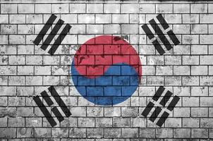 South Korea flag is painted onto an old brick wall photo