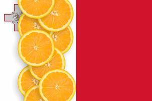 Malta flag and citrus fruit slices vertical row photo