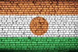 Niger flag is painted onto an old brick wall photo