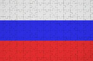 Russia flag  is depicted on a folded puzzle photo