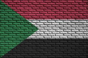 Sudan flag is painted onto an old brick wall photo