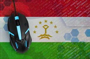 Tajikistan flag  and computer mouse. Digital threat, illegal actions on the Internet photo