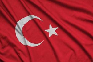 Turkey flag  is depicted on a sports cloth fabric with many folds. Sport team banner photo