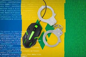 Saint Vincent and the Grenadines flag  and handcuffed computer mouse. Combating computer crime, hackers and piracy photo