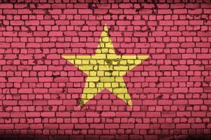 Vietnam flag is painted onto an old brick wall photo