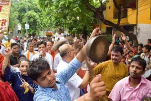 New Delhi, India July 01 2022 - A huge gathering of devotees from different parts of Delhi on the occasion of ratha yatra or rathyatra. Rath for Lord Jagannath pulled by people, Jagannath Rath Yatra photo