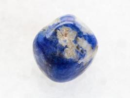 polished Sodalite gemstone on white marble photo