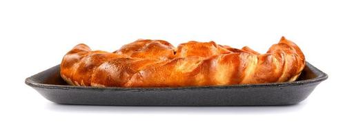 Pie on a plastic substrate. A piece of pie is isolated on a white background. photo