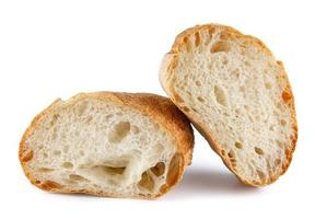 Ciabatta, loaf of bread cut in half isolated on white background. photo