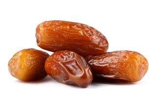 Several delicious dried dates are isolated on a white background. Full clipping path. photo