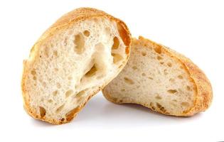 Ciabatta, loaf of bread cut in half isolated on white background. photo