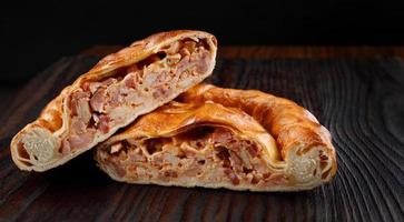 Two pieces of homemade pie on a wooden surface. photo