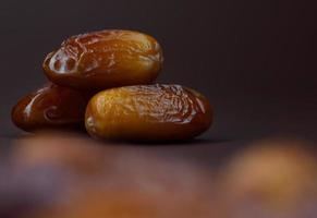Dates lie on a brown background. Ripe dried dates. photo