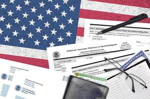 USCIS form I-360 Petition for amerasian, widower or special immigrant lies on flat lay office table and ready to fill. U.S. Citizenship and Immigration services paperwork concept photo