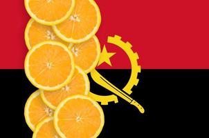 Angola flag and citrus fruit slices vertical row photo