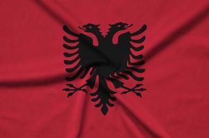Albania flag  is depicted on a sports cloth fabric with many folds. Sport team banner photo