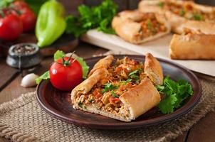 Turkish pide traditional food with beef and vegetables photo