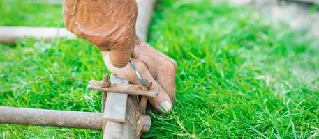 Elderly man twists the nut by wrench photo