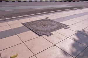 surabaya, june 2022 - cover the sewer wells on the sidewalks of surabaya city photo