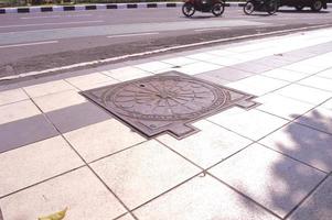 surabaya, june 2022 - cover the sewer wells on the sidewalks of surabaya city photo